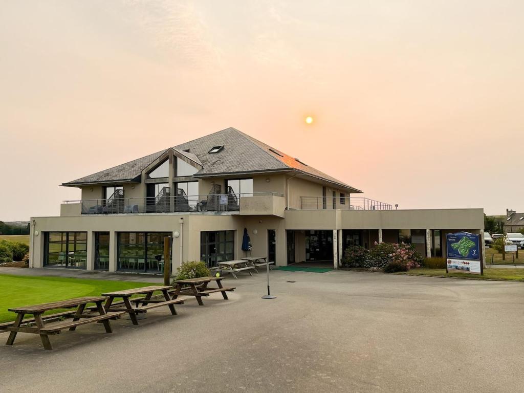 a building with benches in front of it at Appartement T2 N5 calme et cosy sur un golf in Plouarzel
