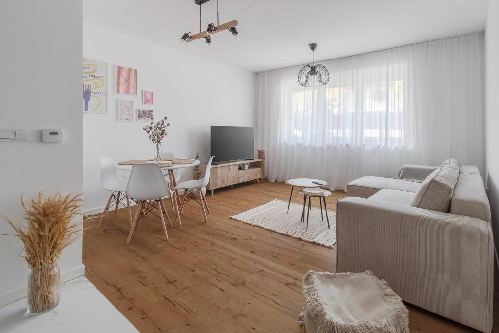 a living room with a couch and a table at Symphony of Light at Waterview in Oradea