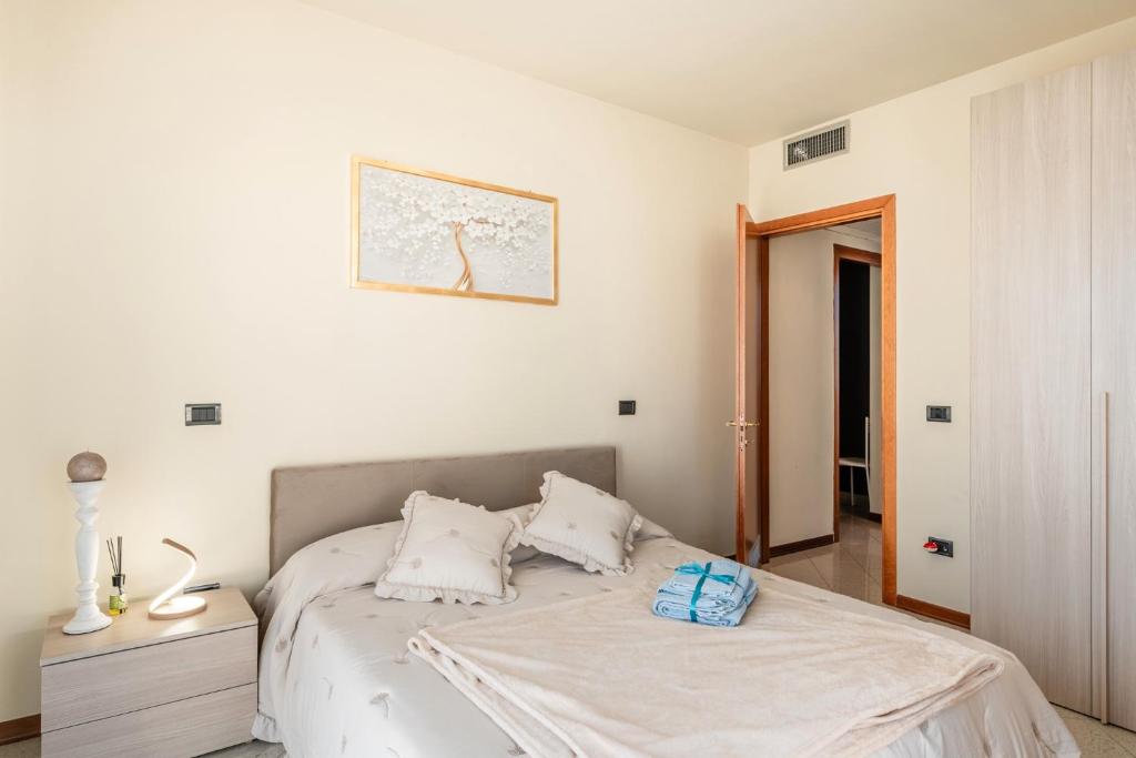 a white bedroom with a bed with two pillows at La Casa di Leo in Stabbia