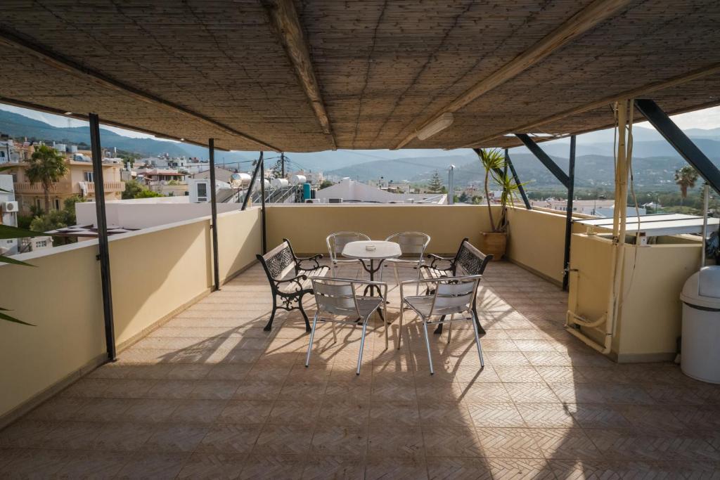 a patio with a table and chairs on a balcony at Vrokastro Apartments in Istro