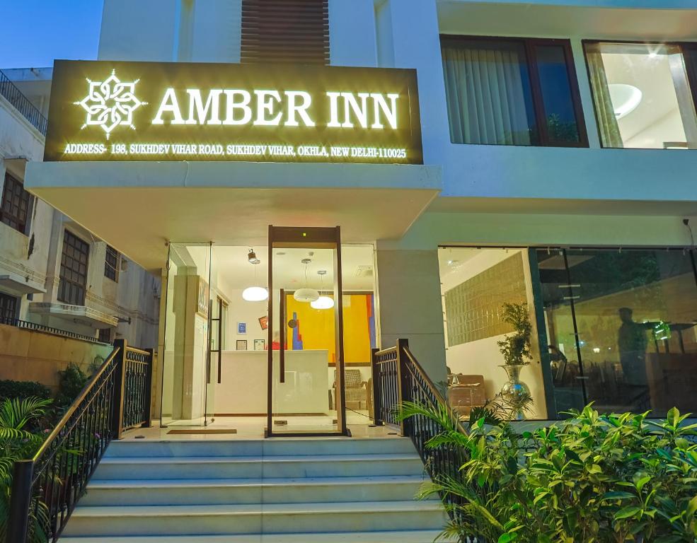 an entrance to a building with a sign that readsamber inn at Amber Inn by Orion Hotels in New Delhi
