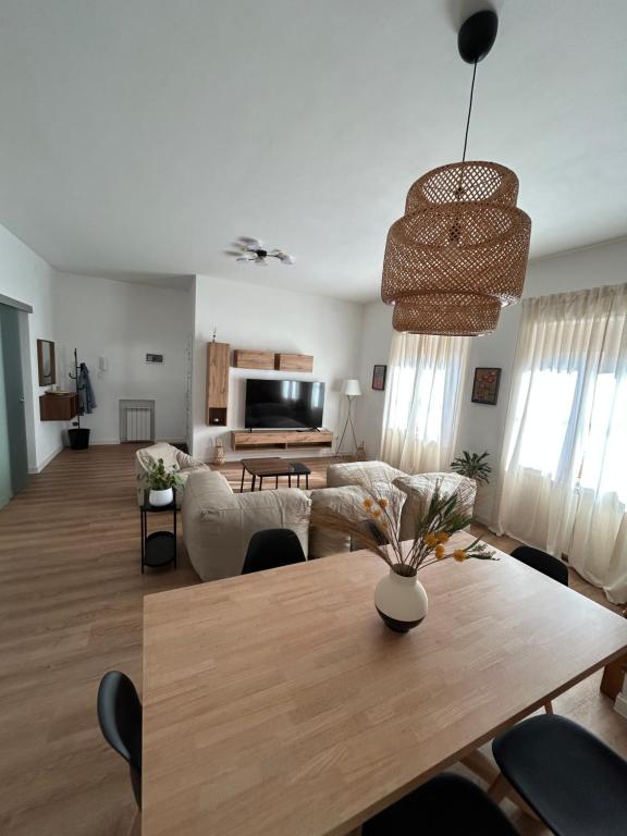 a living room with a table and a couch at Monfalcone Easy Stay WEST in Monfalcone