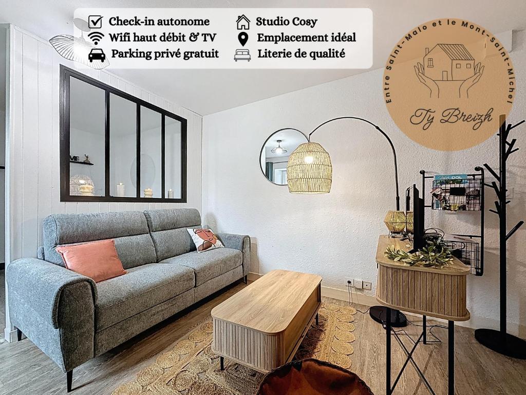 a living room with a couch and a table at Ty Breizh - Studio cosy au cœur de Dol-de-Bretagne in Dol-de-Bretagne