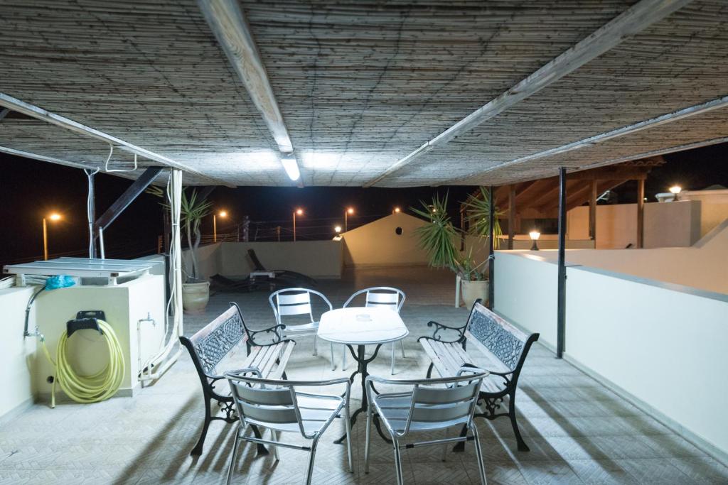 a patio with a table and chairs on a roof at Vrokastro Apartments in Istro