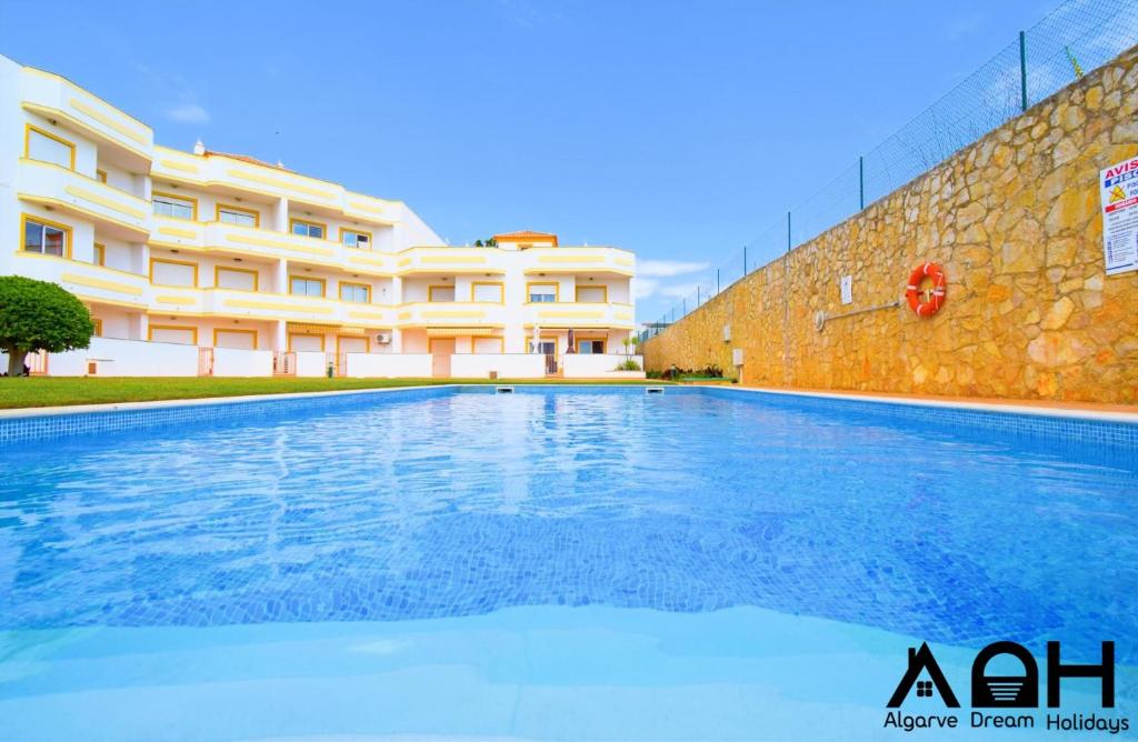 a large swimming pool in front of a building at Luz do Sol in Guia