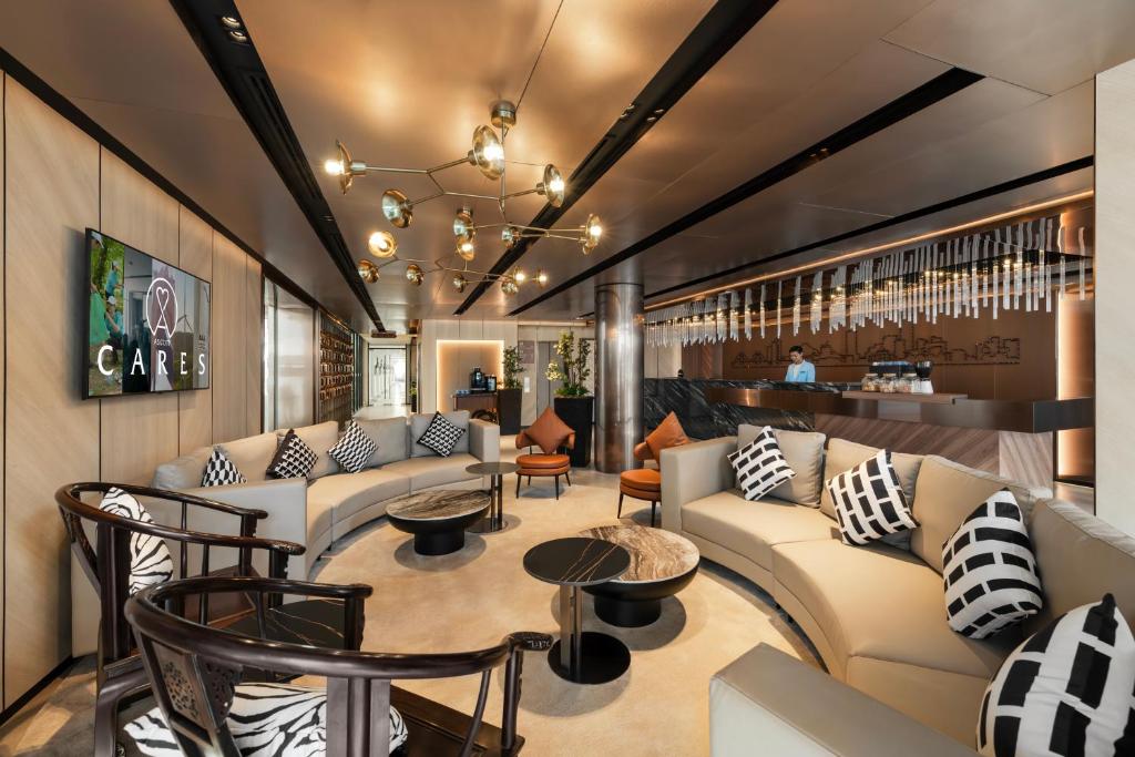 a lobby with couches and tables and a bar at Citadines Connect Bertam Georgetown Penang in George Town