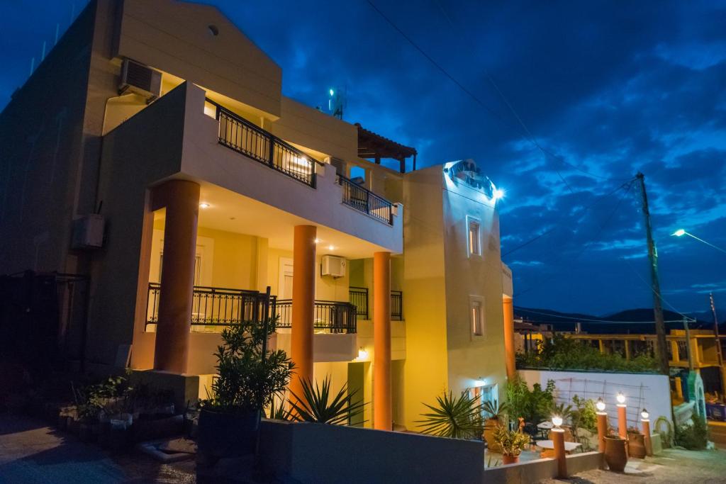 a villa with a lit up facade at night at Vrokastro Apartments in Istro