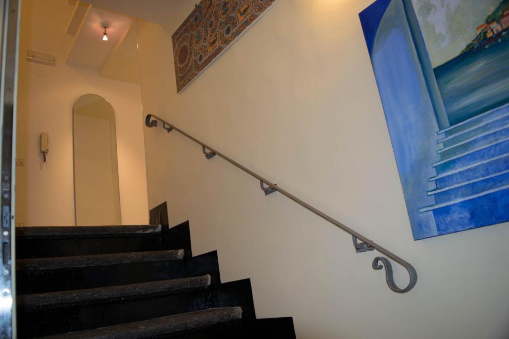 a set of stairs in a building with a painting on the wall at Il Guiscardo B&B in Salerno