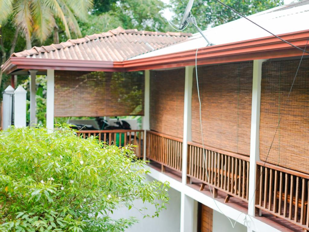 a brick house with a balcony with a roof at Galle Serenity Bliss Private Villa in Galle
