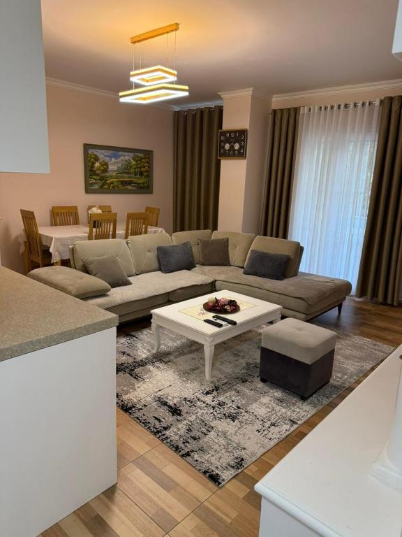 a living room with a couch and a table at Luxury Apartments in Vlorë
