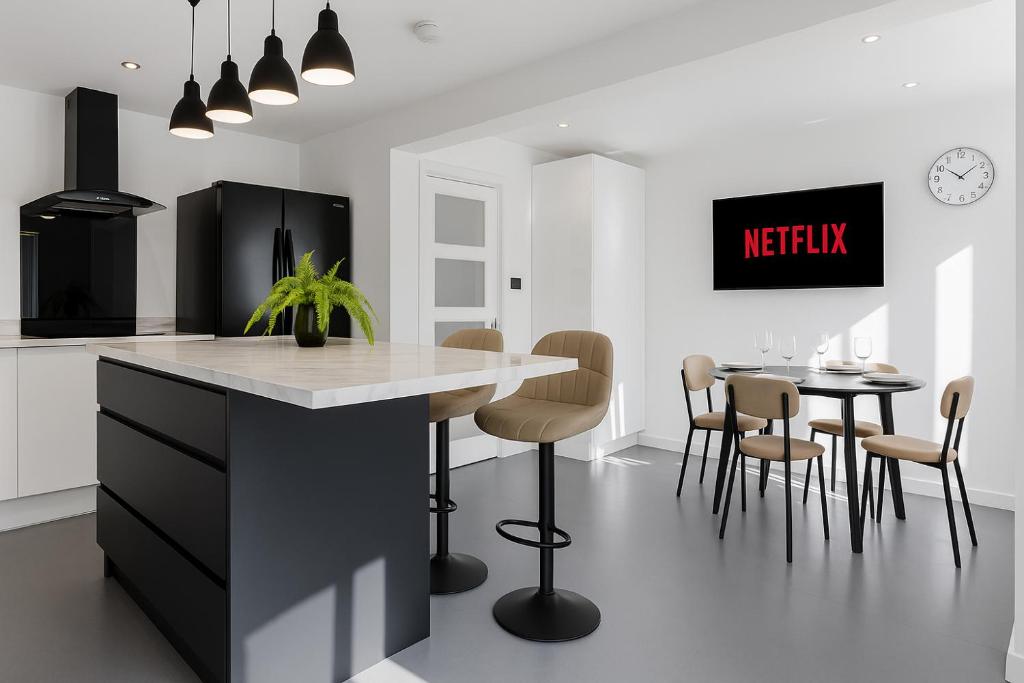 a kitchen with a counter and a table with chairs at Highland House in Birmingham