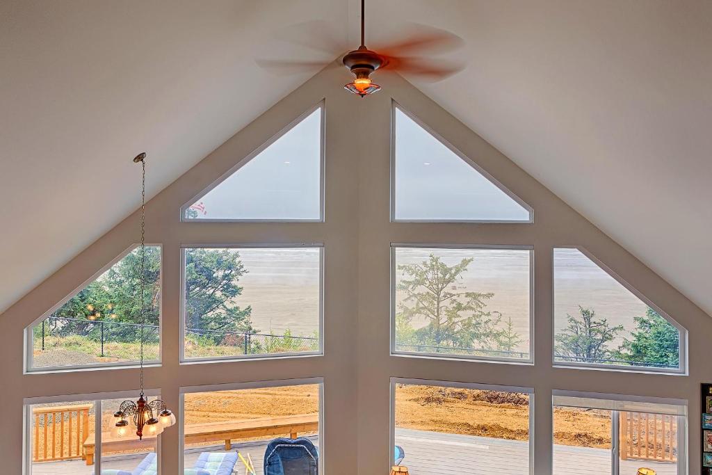 a room with a large window with a ceiling fan at Sand Castle Bluff in Moclips