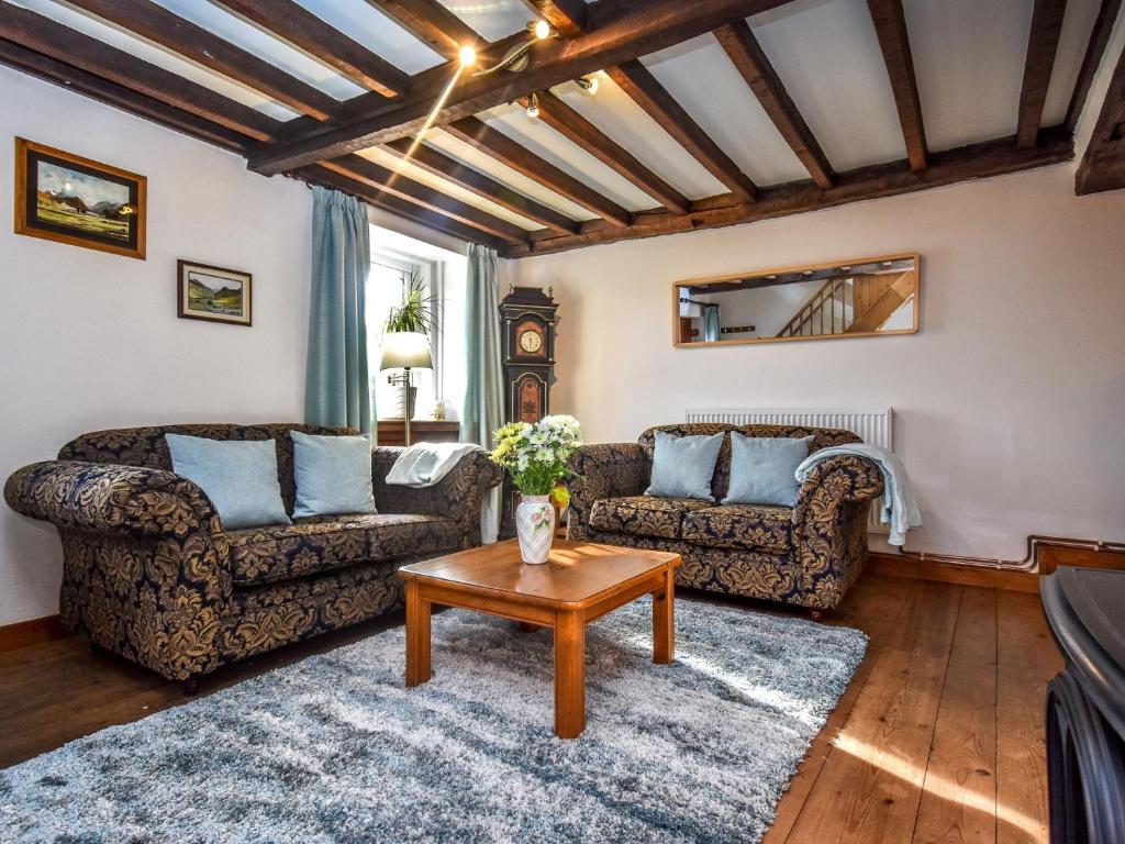 a living room with two couches and a table at 2 Bed in Ullswater SZ276 in Stainton