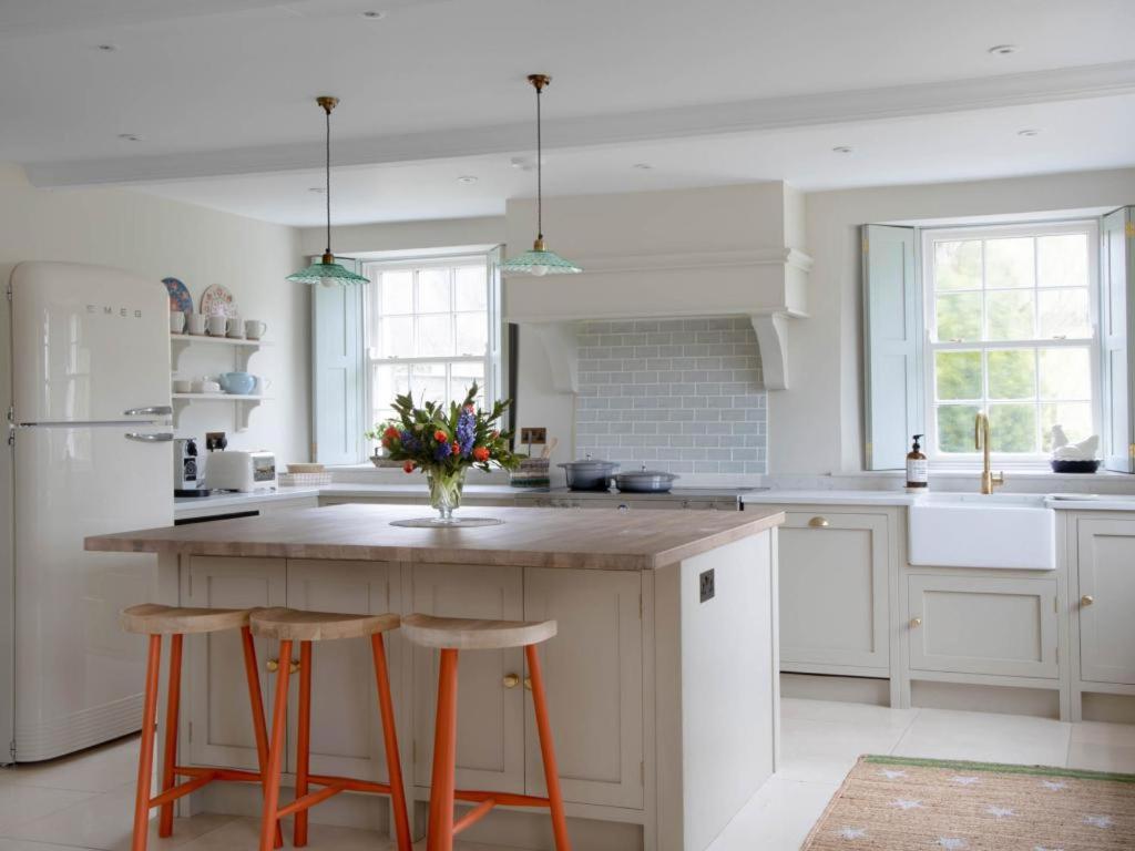 a kitchen with a large island with two stools at 4 Bed in Askham SZ264 in Askham