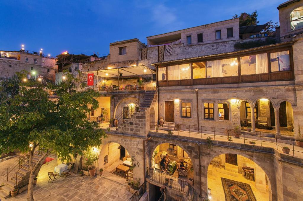 an old building with stairs in a city at night at Century Cave Hotel in Goreme