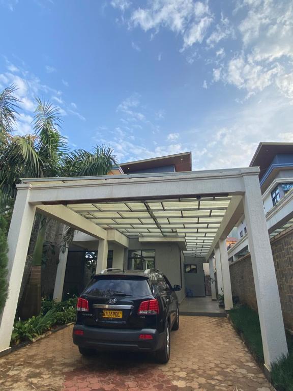 a car parked in front of a building at Secret Stay inn and hotel in Kigali