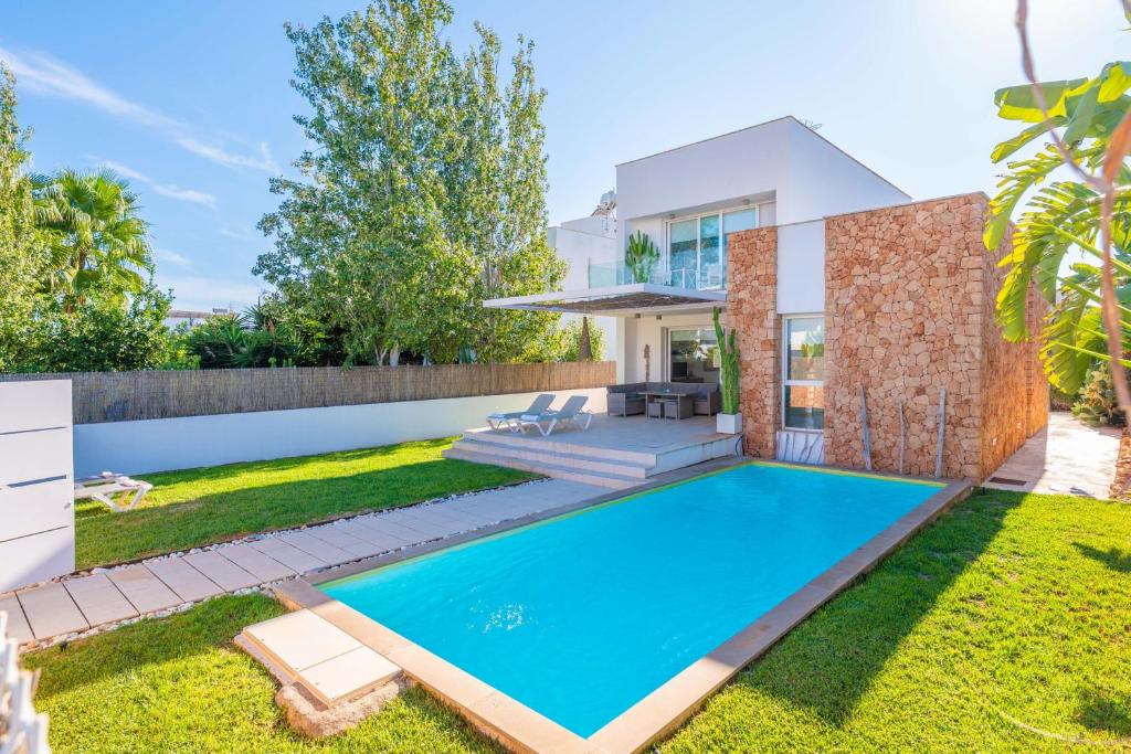a swimming pool in the backyard of a house at Can Bosquerró in Sa Ràpita