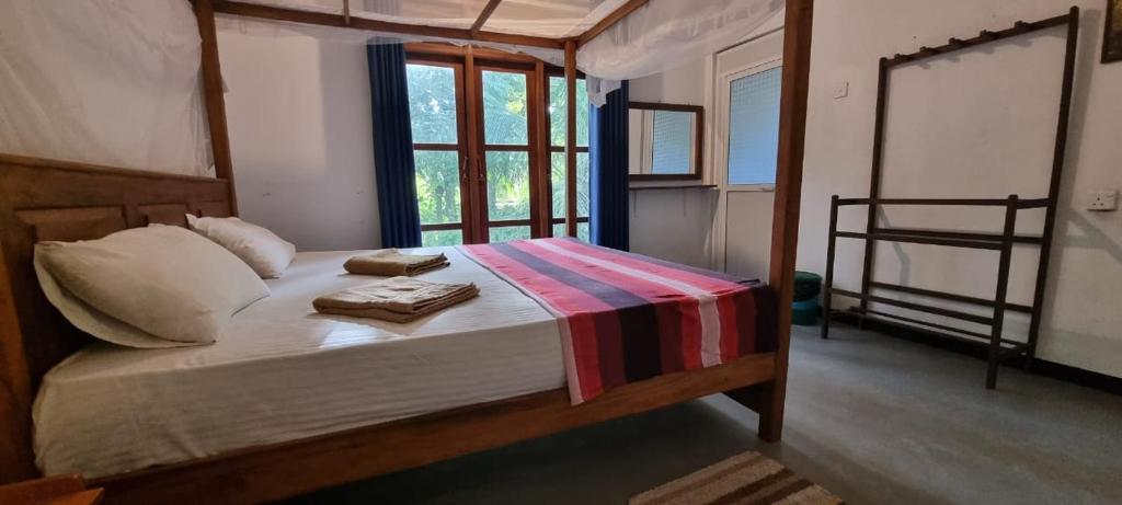 Un dormitorio con una cama con toallas. en place of the jungle, en Hiriketiya