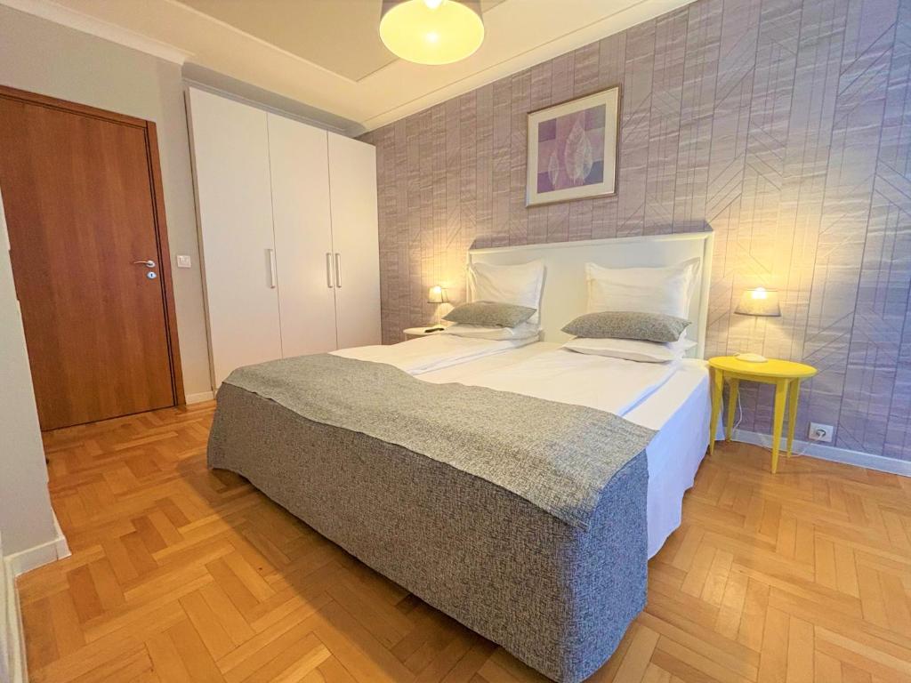 a bedroom with a large bed in a room at Dunav Apart H in Sofia