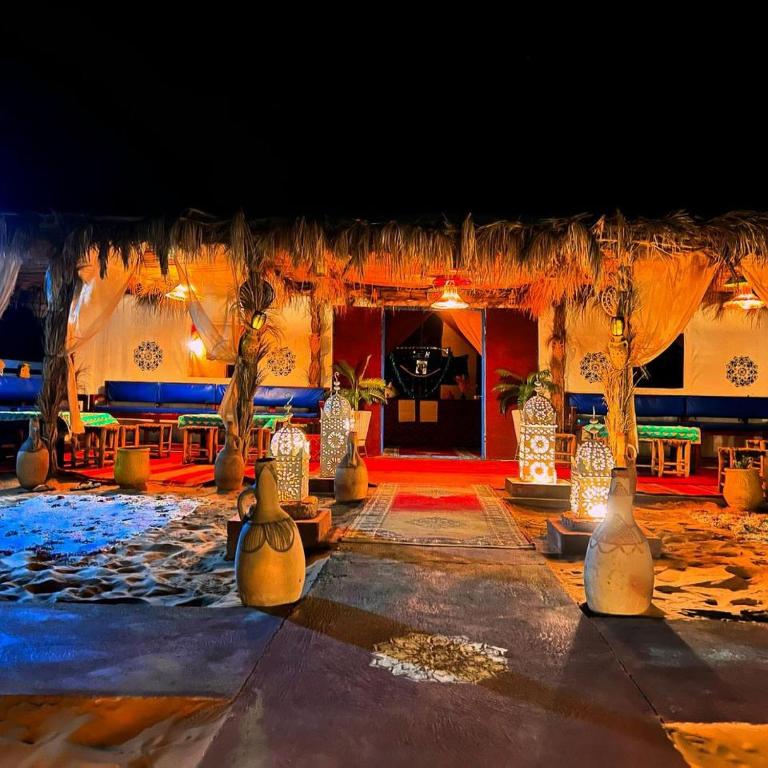 a room with a stage with vases on the floor at Sunlight Luxury Desert Camp in Merzouga