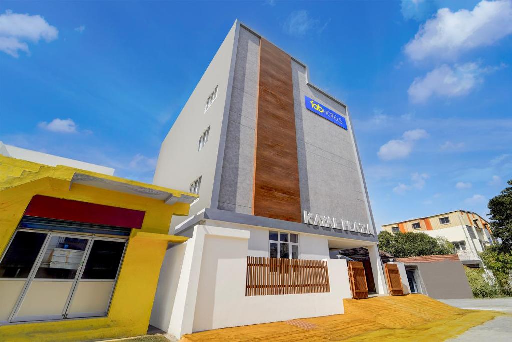 a building with a sign on the side of it at FabHotel Kayal Plaza in Coimbatore
