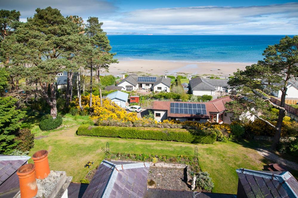 an aerial view of a house with a garden and the ocean at The Penthouse Self Catering in Nairn
