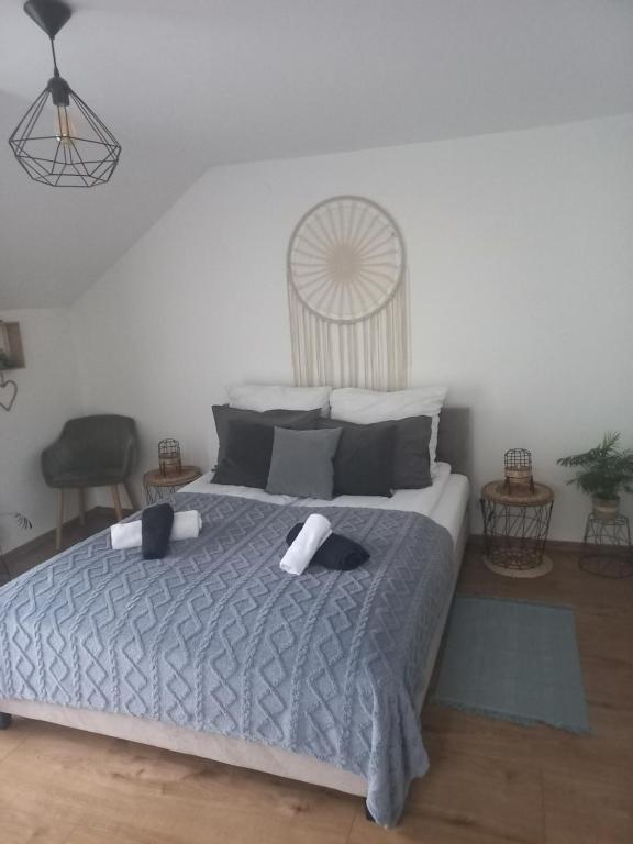 a bedroom with a bed with two towels on it at Apartament w Pieninach in Krościenko