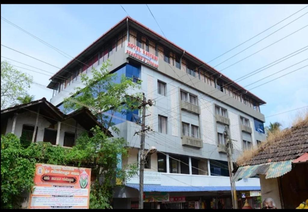 a building with a sign on the side of it at Hotel Kalyani International in Mūlki