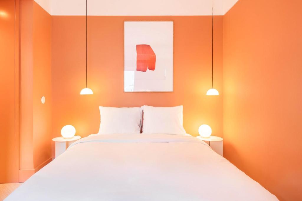 Postel nebo postele na pokoji v ubytování Jardim Suites by Olala Homes