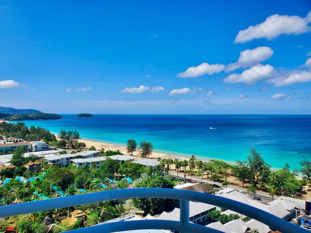 a view of the beach from the balcony of a resort at Waterfront 16D seaview 2 BR apartment - 5 min walk to Karon beach in Karon Beach
