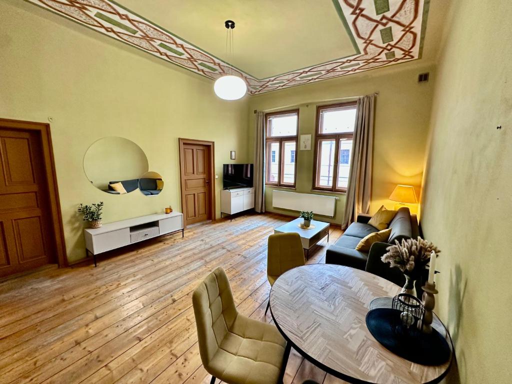 a living room with a couch and a table at Historický stylový apartmán v srdci Hradec Králové in Hradec Králové