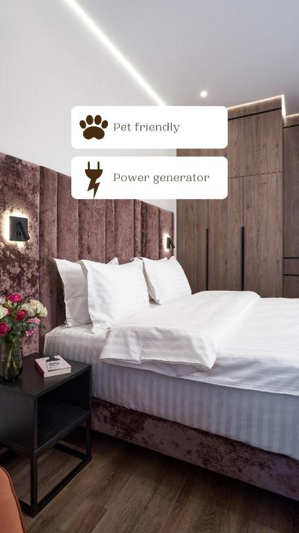 a bedroom with a large bed with white sheets at BonApart Maidan by UHM in Kyiv