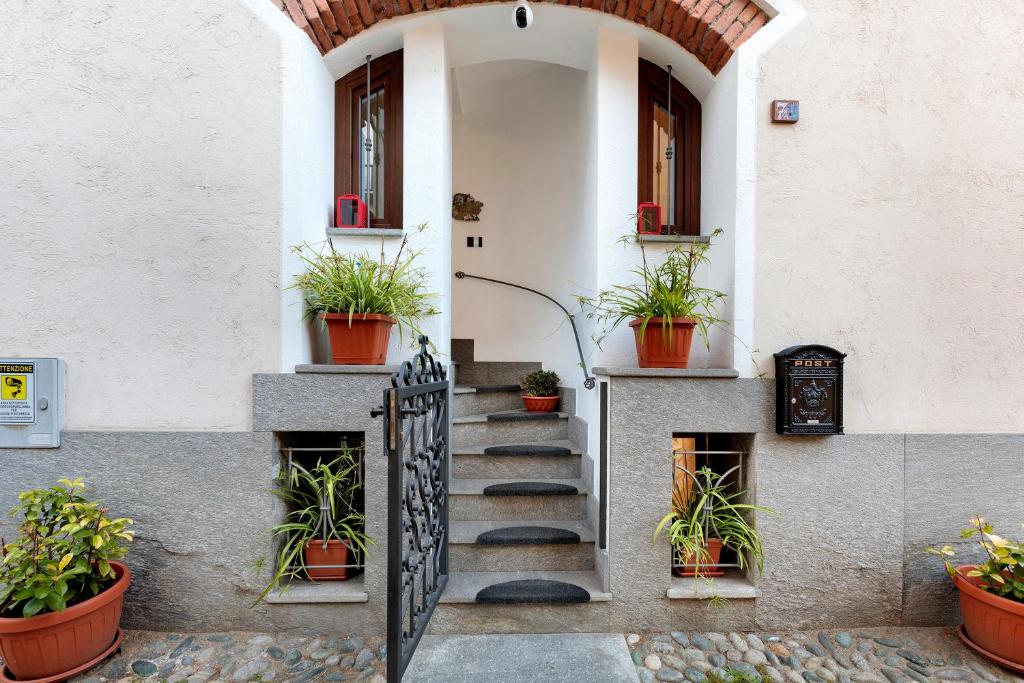 a stairway leading to a building with potted plants at Casa Lara e Gaia - Aosta Centro in Aosta