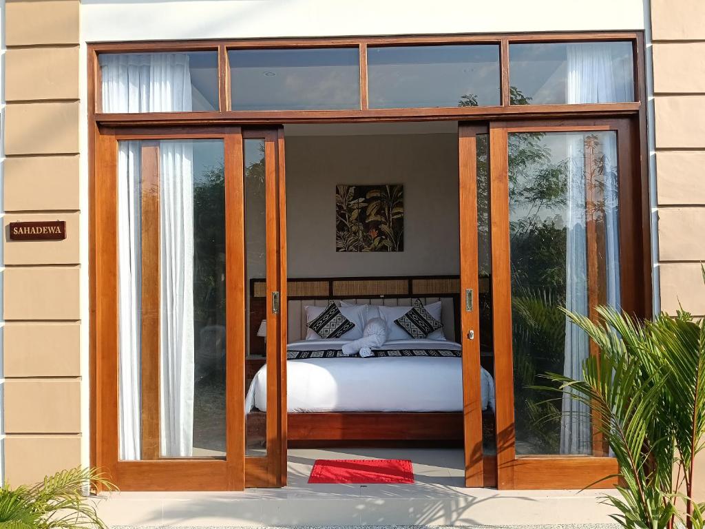 a bedroom with glass doors and a bed inside at The Green Sidemen in Silebeng