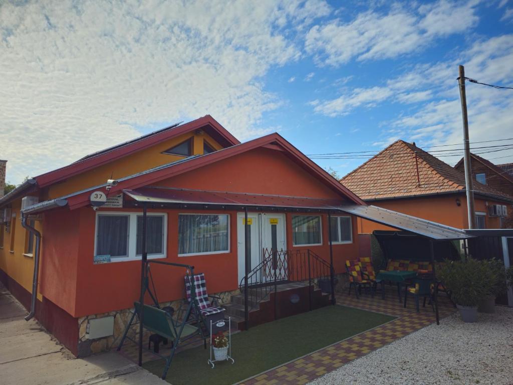 a small red house with a green yard at Family Friendly Gyál in Gyál