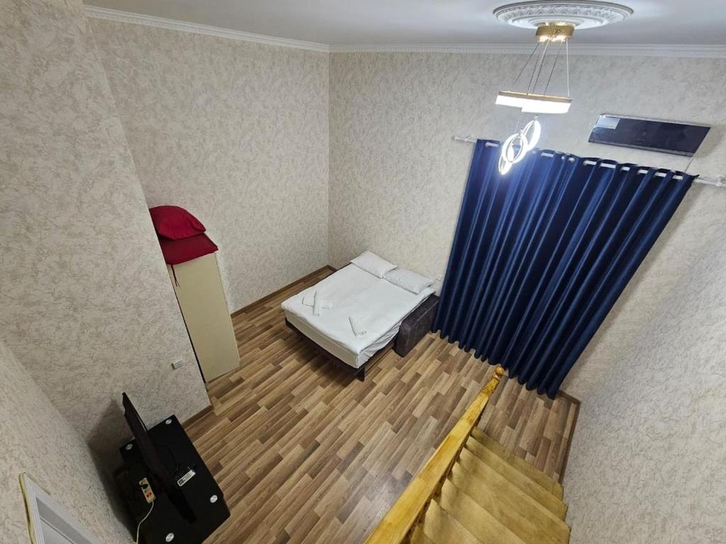 a small room with a bed and a curtain at Nizami 37 in Baku