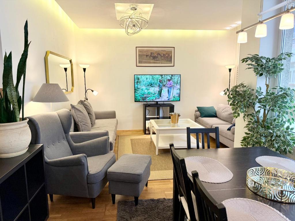 a living room with a couch and a table at Pilies23 Old Town Luxury Apartment in Vilnius