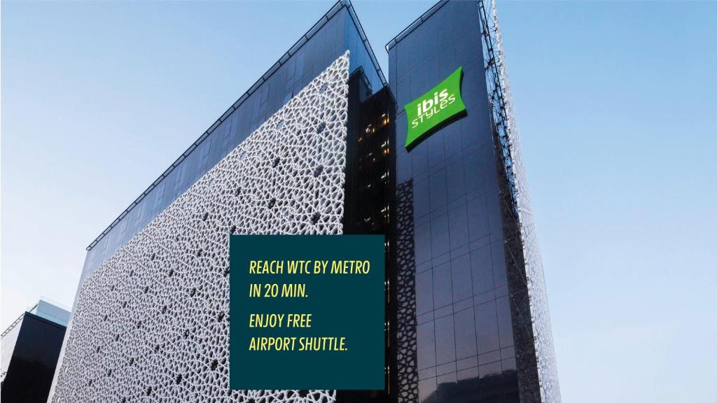 a building with a sign on the side of it at ibis Styles Dubai Airport Hotel in Dubai