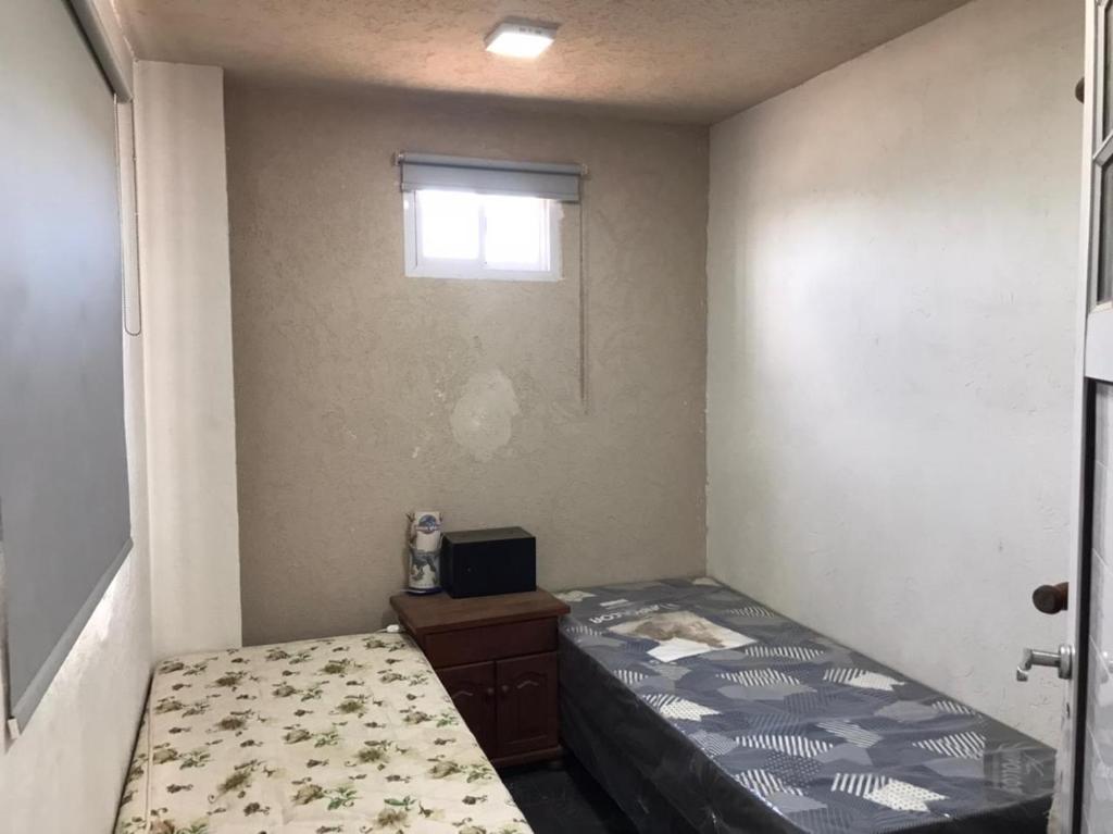 a small bedroom with a bed and a window at casa con vista 360 a las montañas y pileta in Tanti