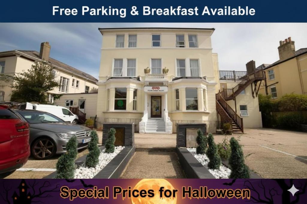 a white house with a car parked in front of it at OYO Eagle House Hotel, St Leonards Hastings in St. Leonards