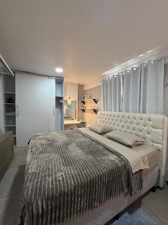 a bedroom with a large bed with a large couch at STUDIO 201 | WIFI 600MB | RESIDENCIAL JC, um lugar para ficar. in Belém