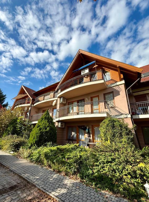 a building with balconies on the side of it at Beach Apartman by HelloBalatonlelle in Balatonlelle