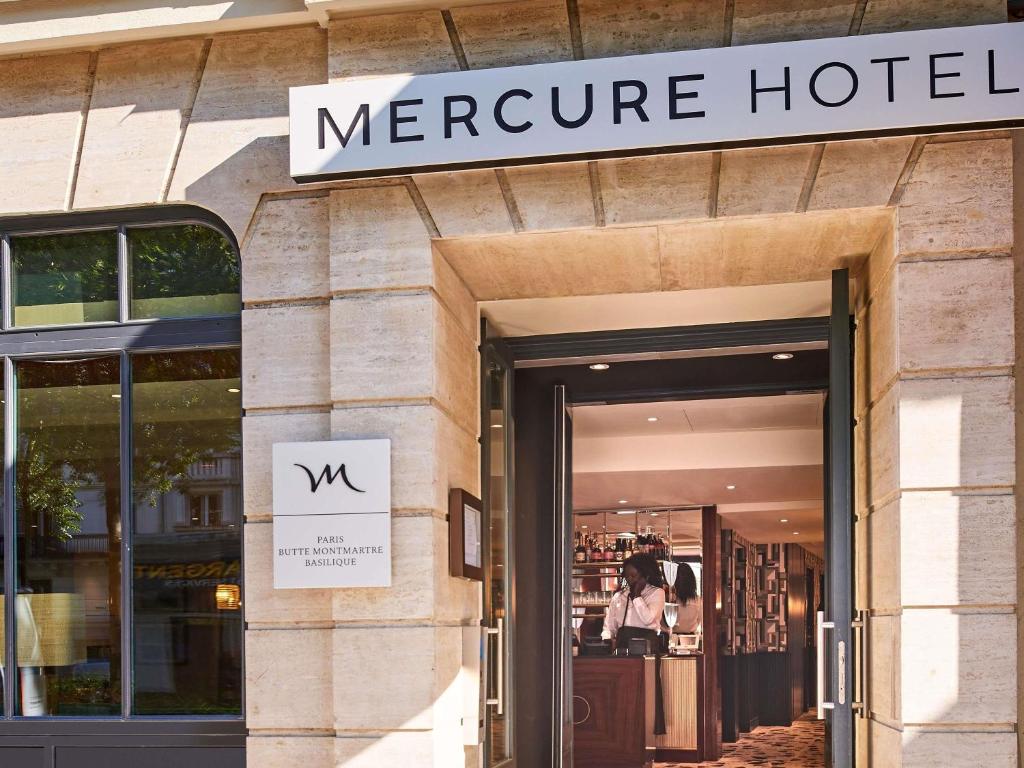 a store front of a mire hotel with a sign on it at Mercure Paris Butte Montmartre Basilique in Paris