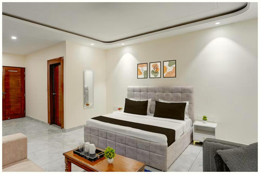 a bedroom with a large bed and a living room at Hotel SR Palace Residency Near Jagannath in Kathmandu