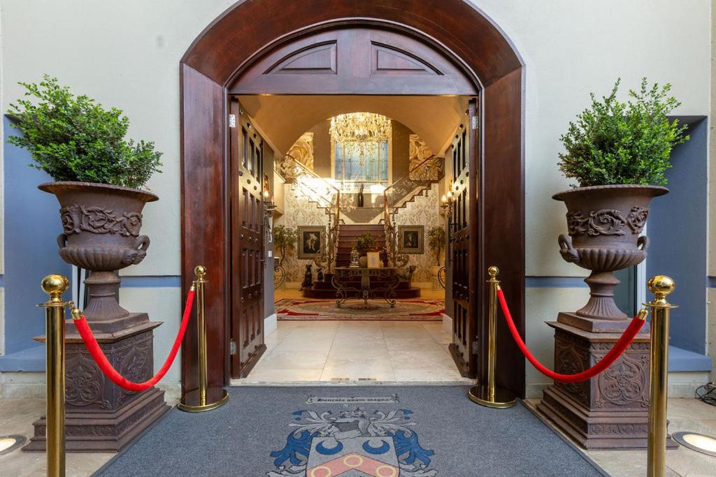 an entrance to a house with two red ribbon at The 506 Hotel in Midrand