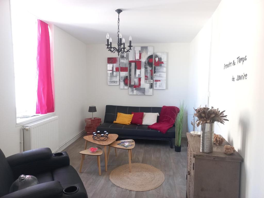 a living room with a couch and a table at L'Appart Sud Vendée in Saint-Hilaire-des-Loges