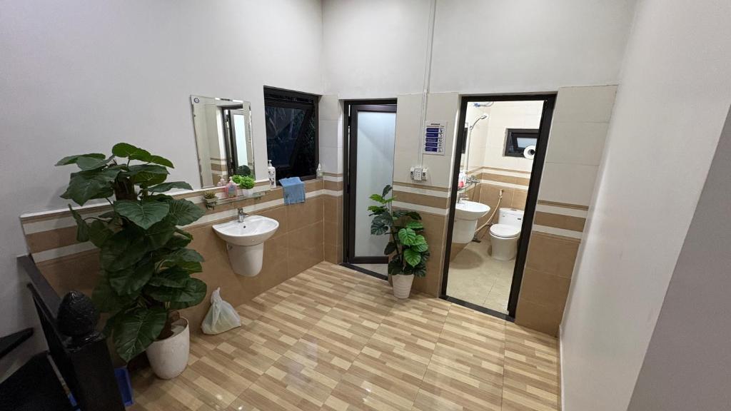 a bathroom with two toilets and a sink and a mirror at Mikey House Ha Giang - Tour Operator & Homestay in Làng Xa