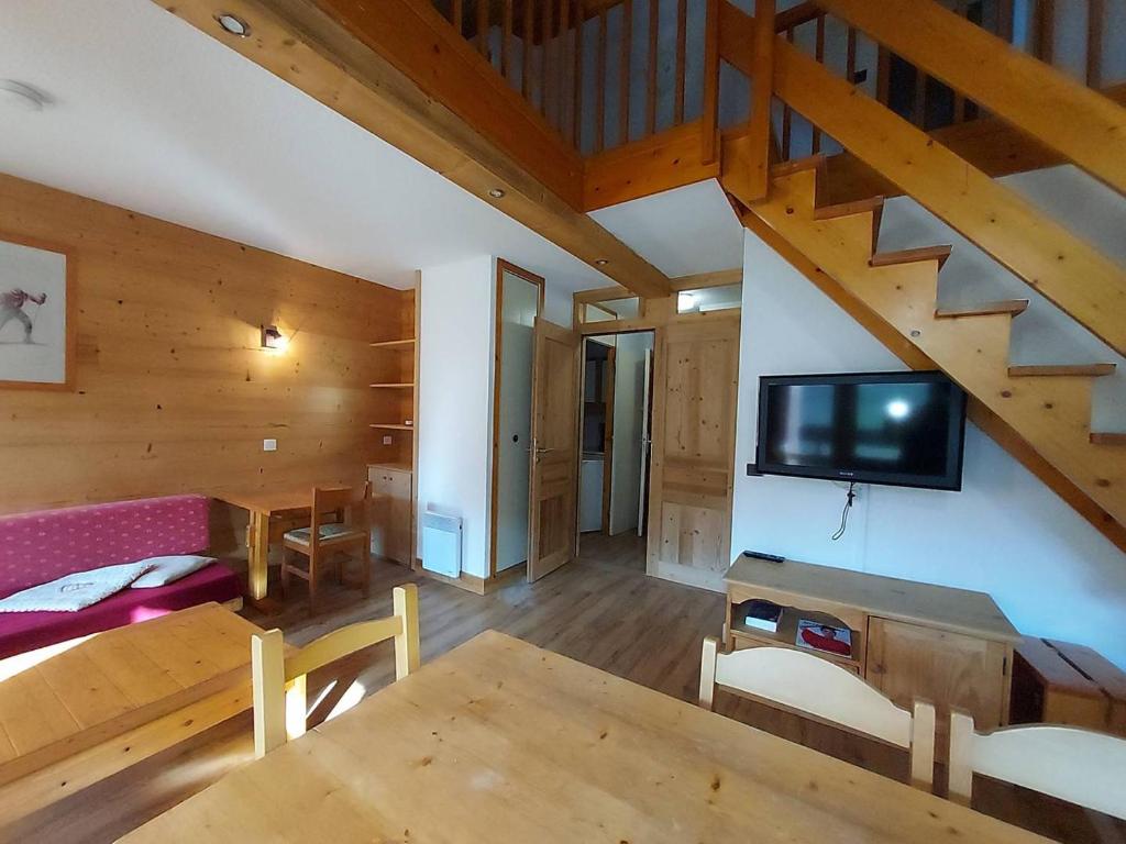 a living room with a tv and a wooden ceiling at Duplex spacieux 3P à 20m des pistes, idéal famille, balcon, casier à skis - FR-1-356-269 in Valmorel