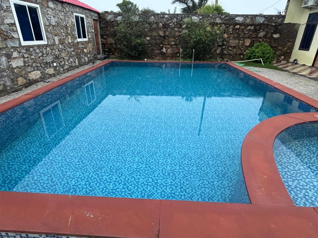 a large swimming pool with blue water at Angel hill resort in Chonp