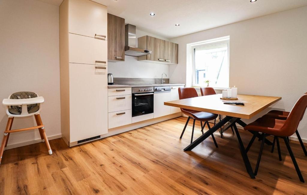 a kitchen with a wooden table and a dining room at Apartment in Inzing in Inzing